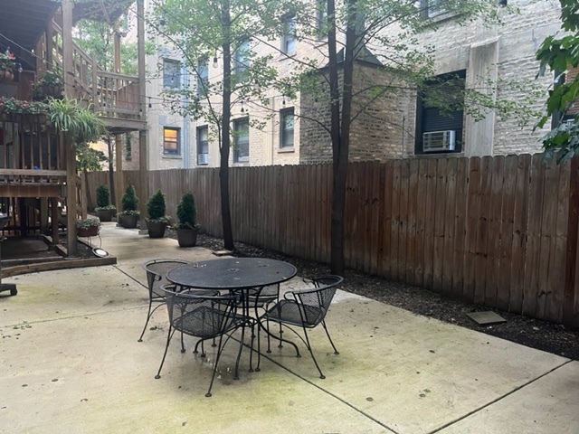 501 West Belmont Avenue, Unit 1 Chicago, IL 60657 - Photo 10 of 17 a view of backyard with table and chairs and potted plants