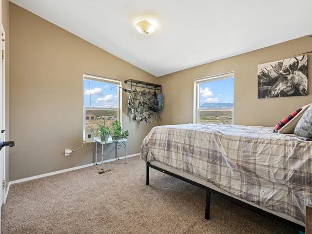 a bed sitting in a bedroom next to a window