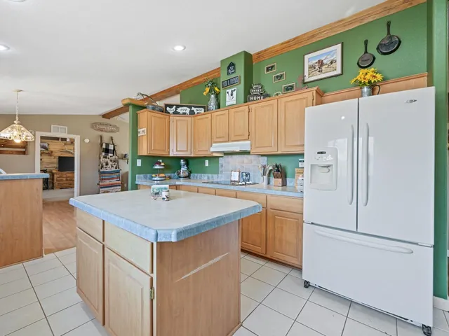 a kitchen with stainless steel appliances granite countertop a refrigerator sink and cabinets