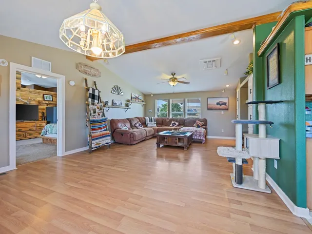 a living room with furniture and a chandelier