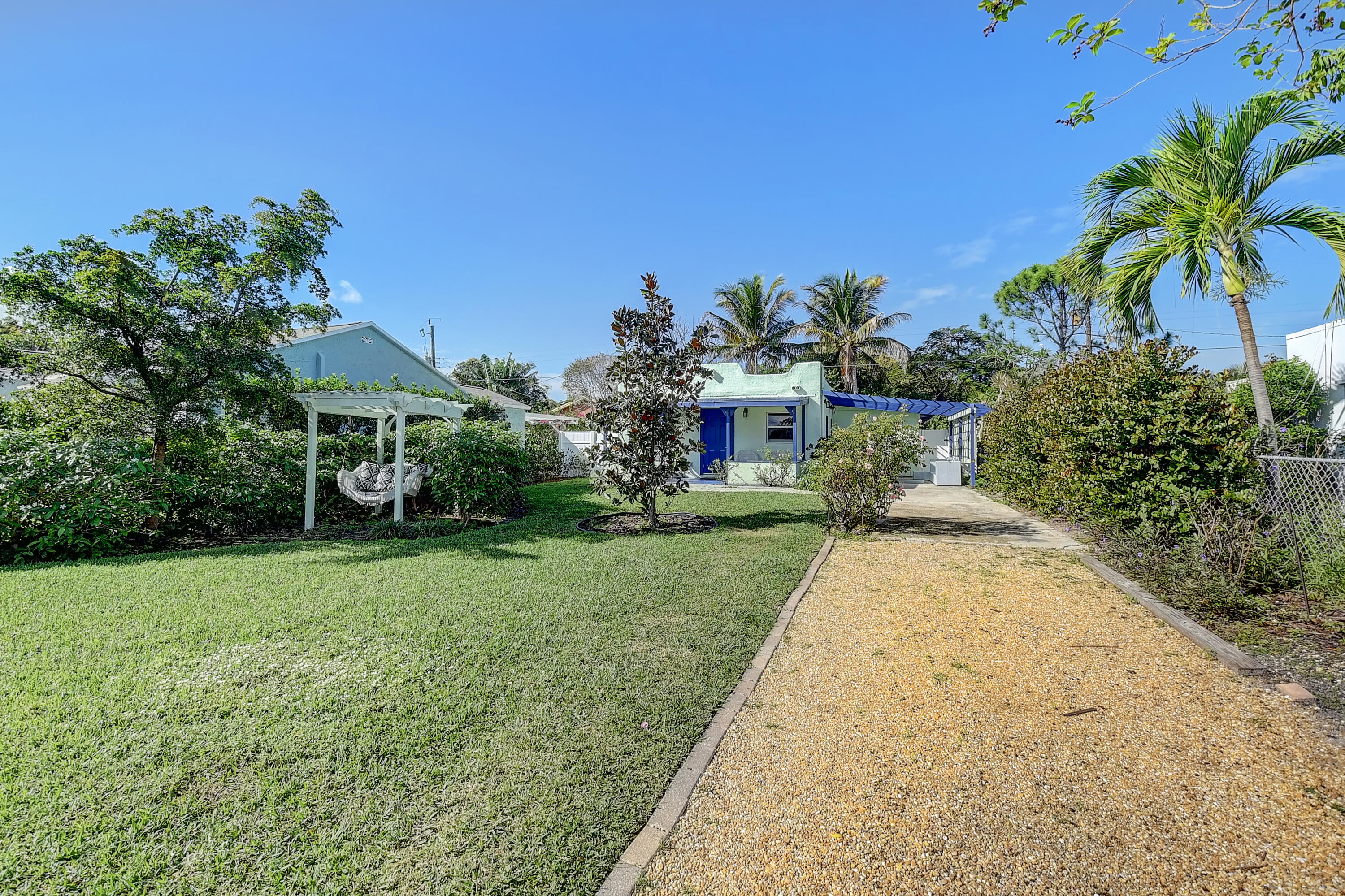 212 Southwest 1st Avenue Delray Beach, FL 33444 - Photo 1 of 15 a view of a backyard with a garden and plants