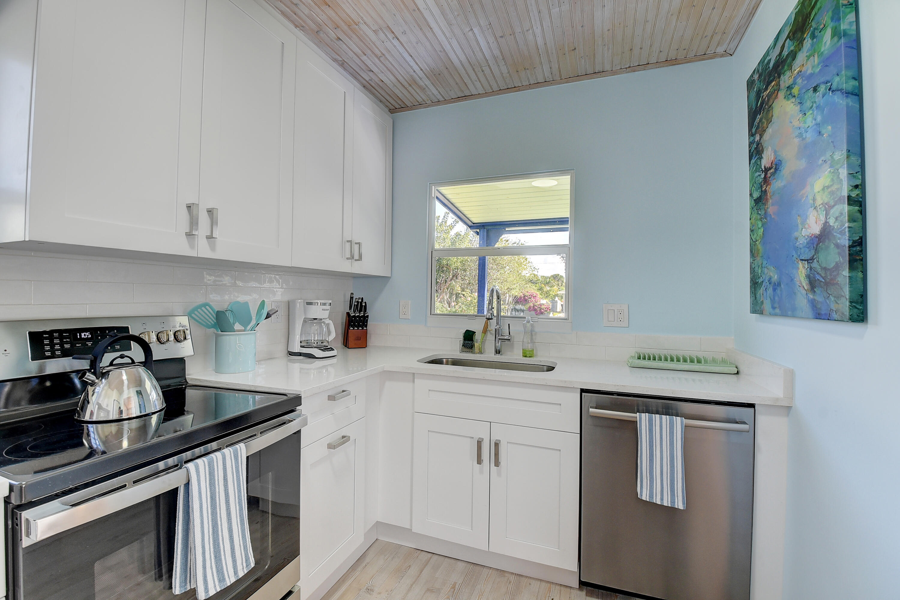 212 Southwest 1st Avenue Delray Beach, FL 33444 - Photo 11 of 15 a kitchen with granite countertop white cabinets and white appliances