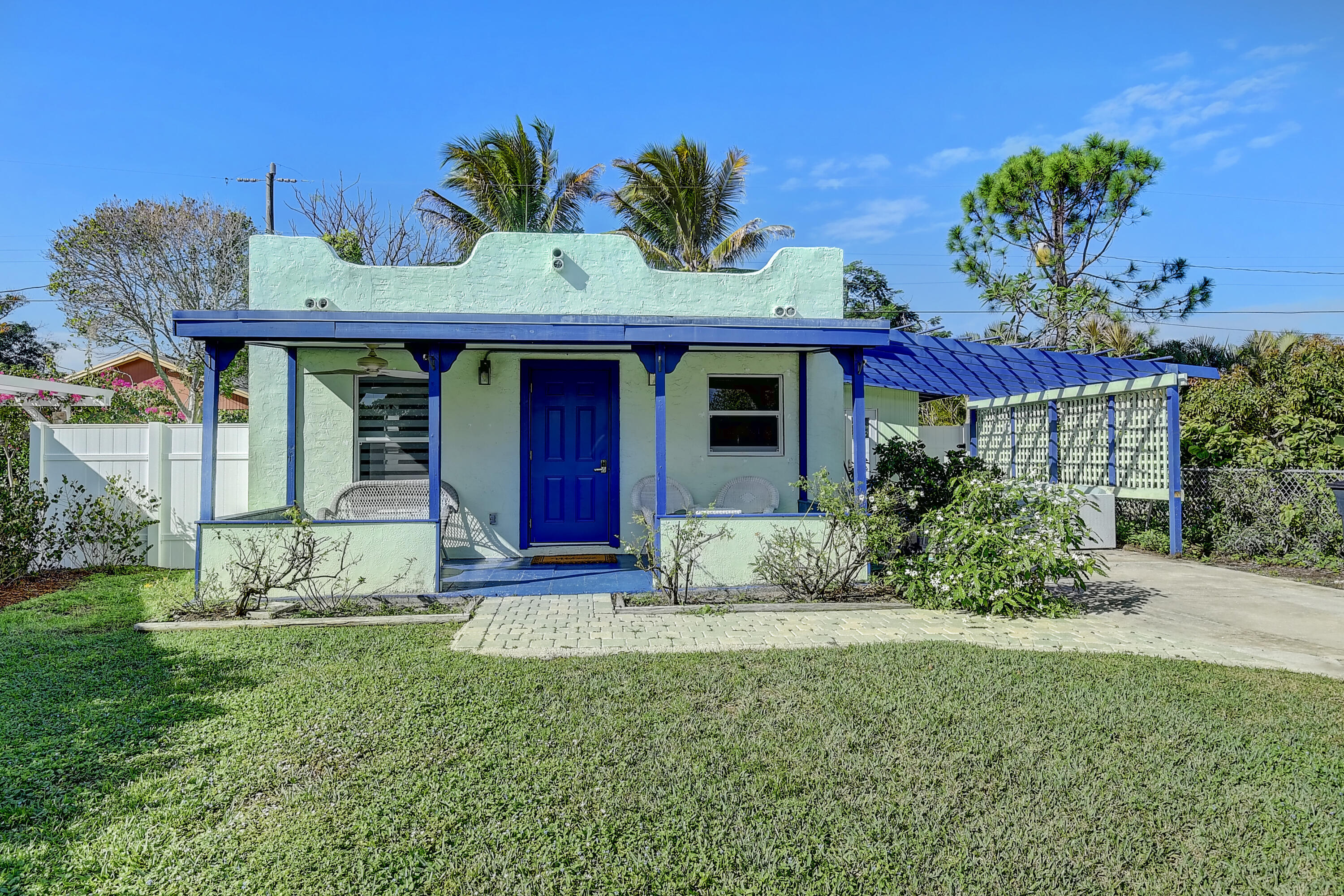 212 Southwest 1st Avenue Delray Beach, FL 33444 - Photo 2 of 15 a view of a house with table and chairs potted plants
