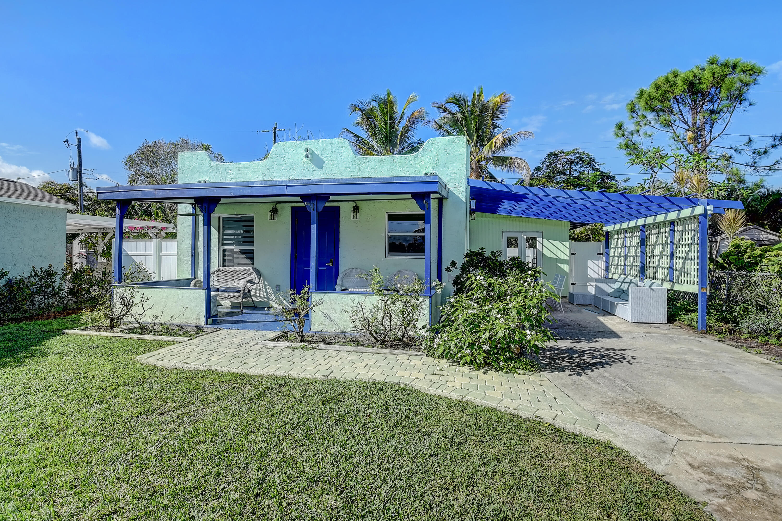 212 Southwest 1st Avenue Delray Beach, FL 33444 - Photo 3 of 15 a view of a house with a small yard and potted plants