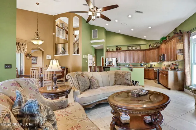 a view of a dining room with furniture wooden floor and chandelier