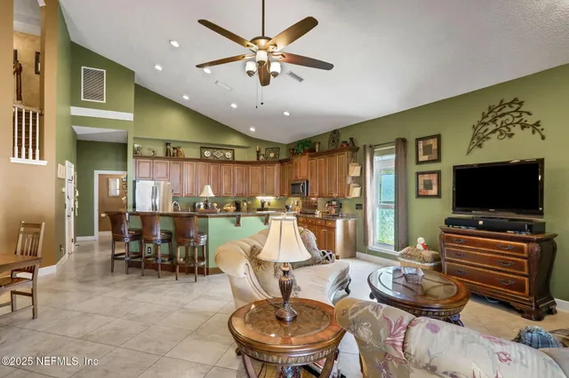 a view of a livingroom with furniture and a floor to ceiling window