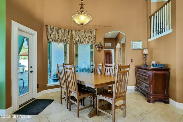 a spacious bedroom with a bed and a chandelier