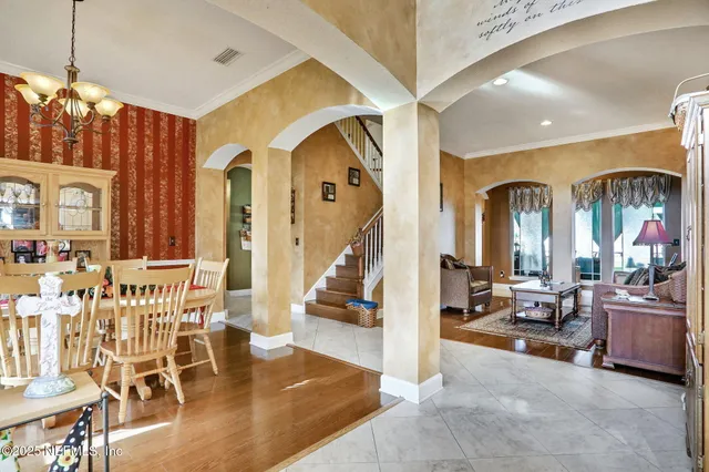 a view of a hallway with windows and furniture