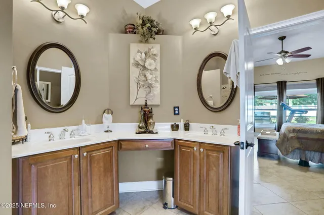 a view of an empty room with a fireplace and a chandelier fan
