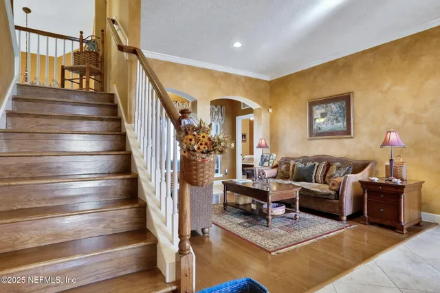 a kitchen with a stove a sink and a wooden floors