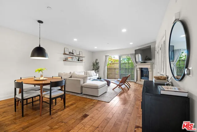 a living room with fireplace furniture and a wooden floor