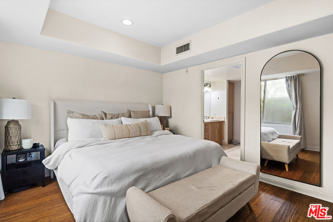 8238 West Manchester Avenue, Unit 204 Playa del Rey, CA 90293 - Photo 12 of 23 a bedroom with a bed and wooden floor