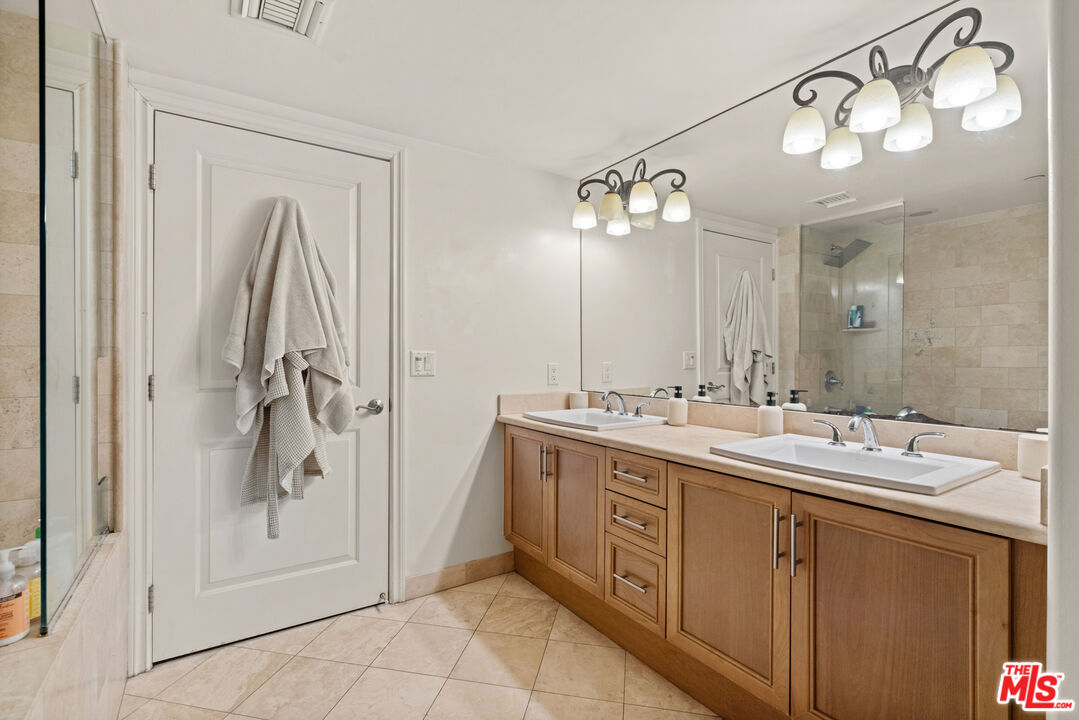 8238 West Manchester Avenue, Unit 204 Playa del Rey, CA 90293 - Photo 14 of 23 a spacious bathroom with a double vanity sink mirror and shower