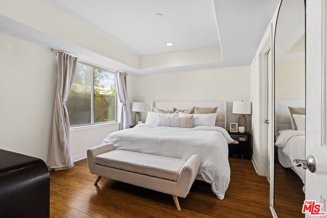 8238 West Manchester Avenue, Unit 204 Playa del Rey, CA 90293 - Photo 3 of 23 a bedroom with a bed and wooden floor