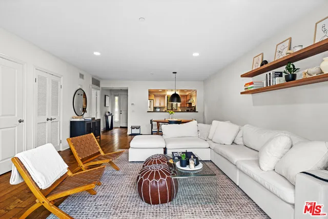 a living room with furniture a rug and a lamp