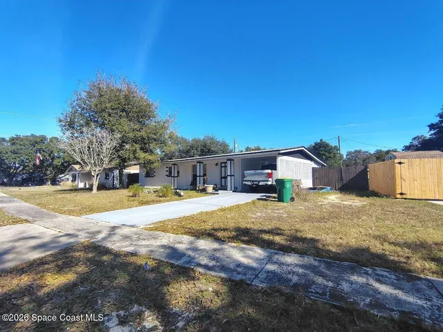 a view of a house with swimming pool and sitting area