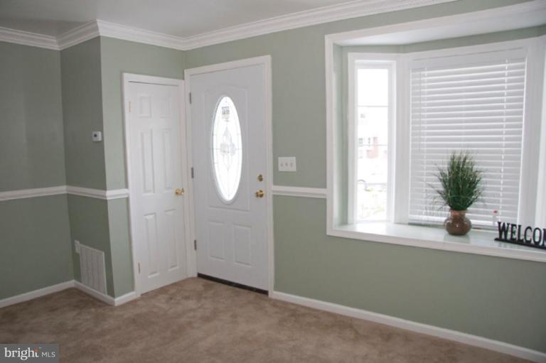 1949 Quentin Road Dundalk, MD 21222 - Photo 13 of 21 an empty room with windows and entrance