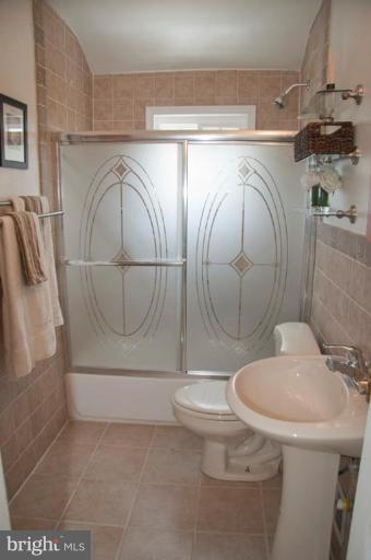 1949 Quentin Road Dundalk, MD 21222 - Photo 18 of 21 a bathroom with a sink and mirror