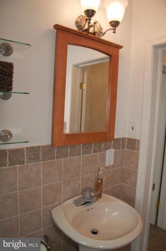 1949 Quentin Road Dundalk, MD 21222 - Photo 19 of 21 a bathroom with a sink a mirror and vanity