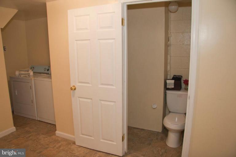 1949 Quentin Road Dundalk, MD 21222 - Photo 4 of 21 a bathroom with a granite countertop toilet and a sink