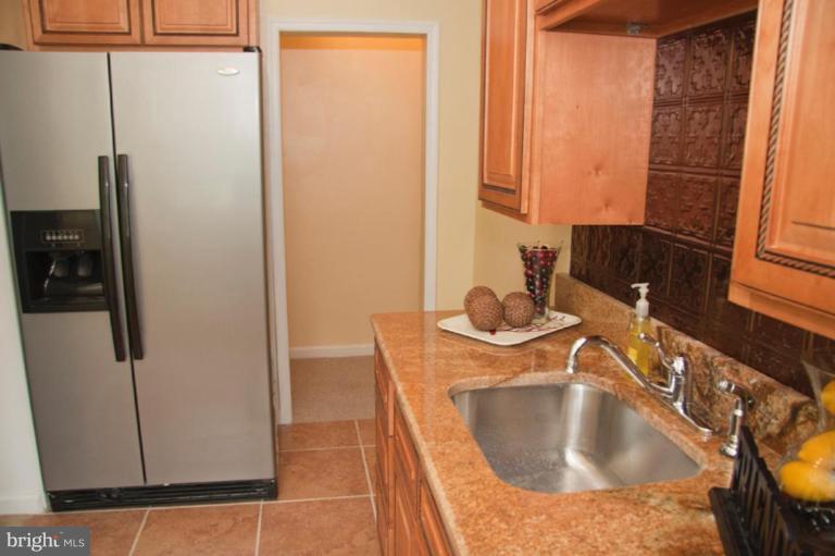 1949 Quentin Road Dundalk, MD 21222 - Photo 7 of 21 a kitchen with a sink and a refrigerator