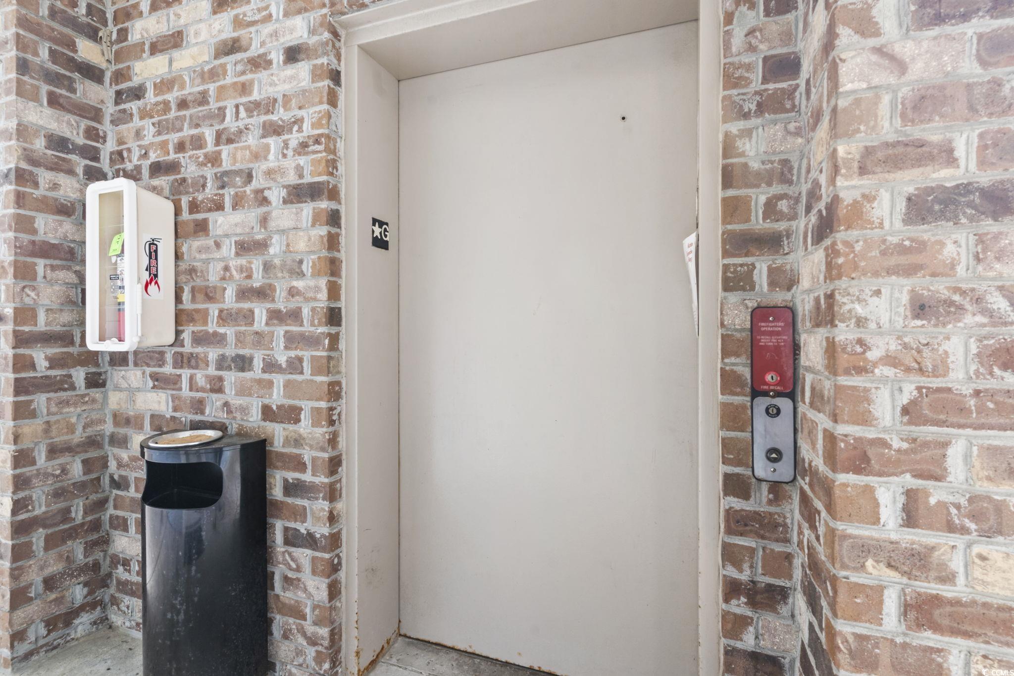 4847 Luster Leaf Circle, Unit 301 Myrtle Beach, SC 29577 - Photo 11 of 16 Dining area featuring crown molding, a ceiling fan, wood finished floors, washing machine and clothes dryer, and a wainscoted wall