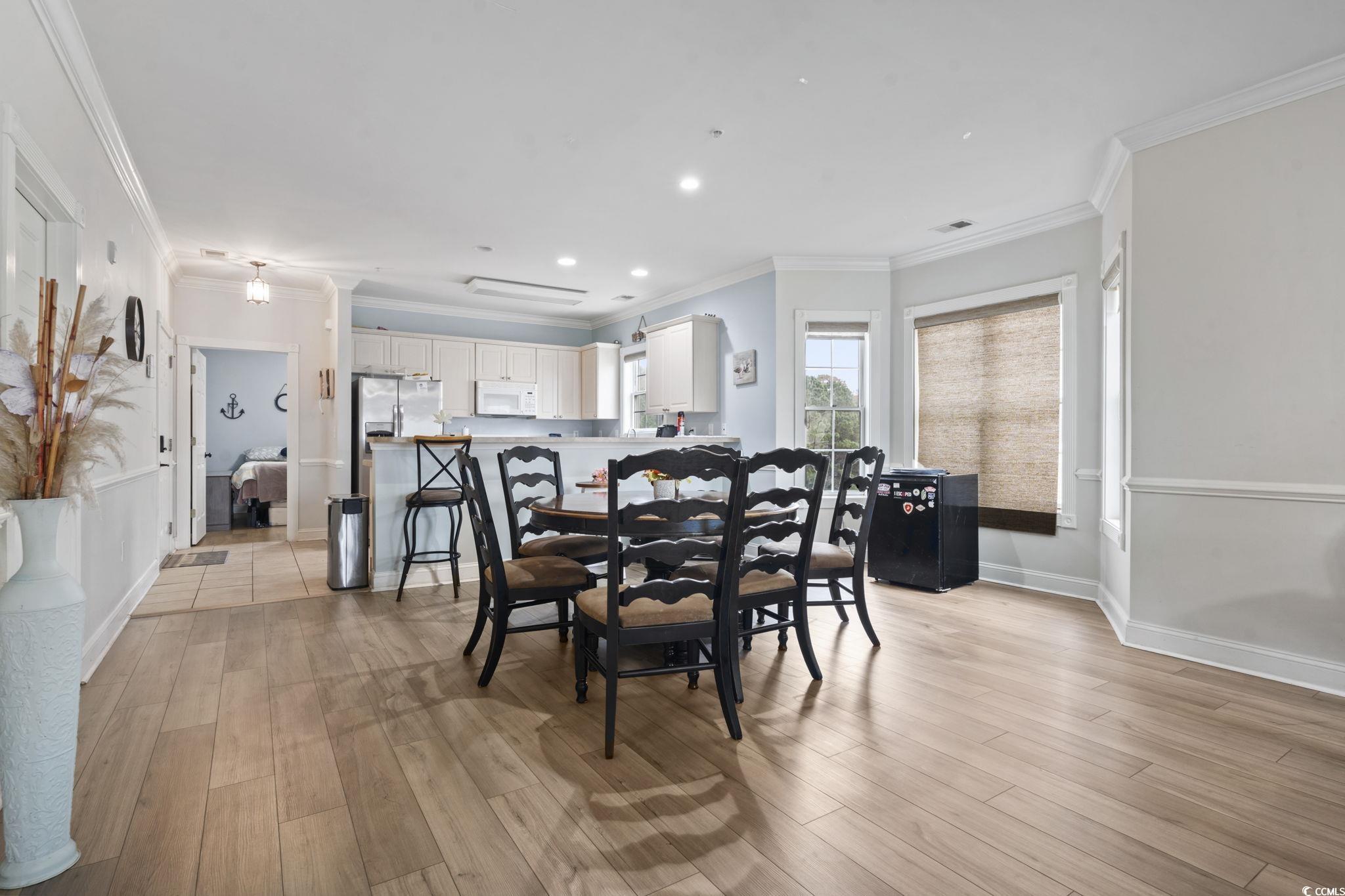 4847 Luster Leaf Circle, Unit 301 Myrtle Beach, SC 29577 - Photo 5 of 16 Dining space featuring light wood-style floors, ornamental molding, and recessed lighting