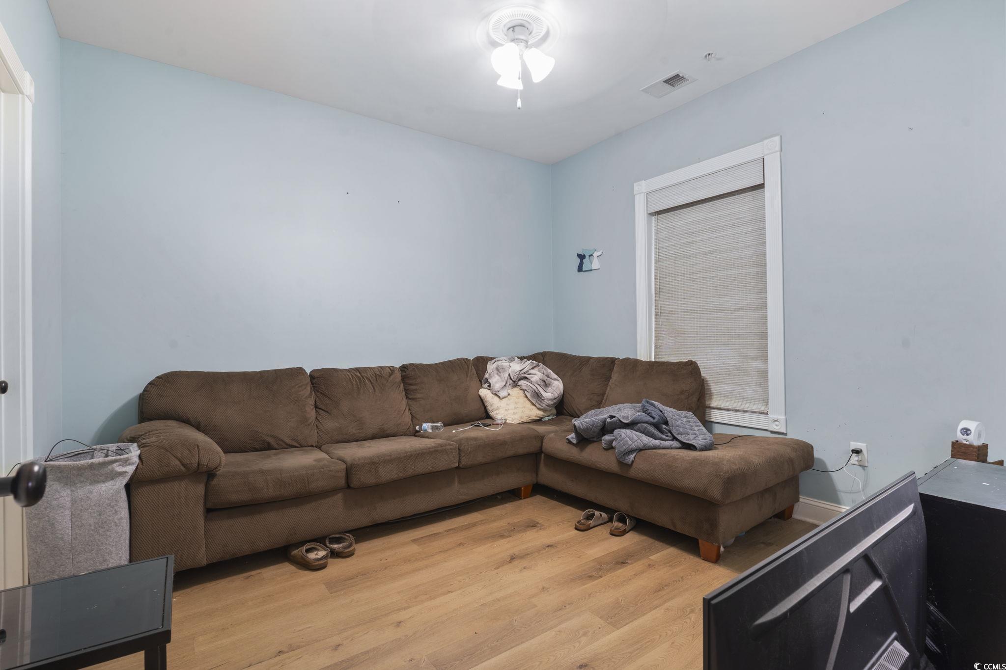 4847 Luster Leaf Circle, Unit 301 Myrtle Beach, SC 29577 - Photo 9 of 16 Living area featuring light wood finished floors