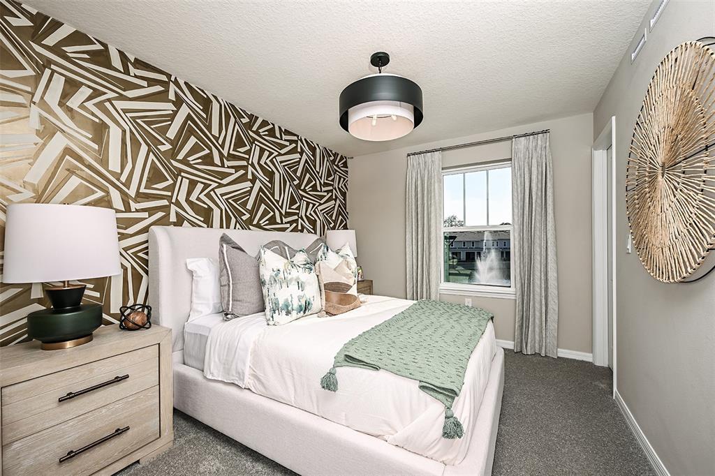 551 Southern Edge Way Sanford, FL 32771 - Photo 13 of 15 a bedroom with a bed and a window