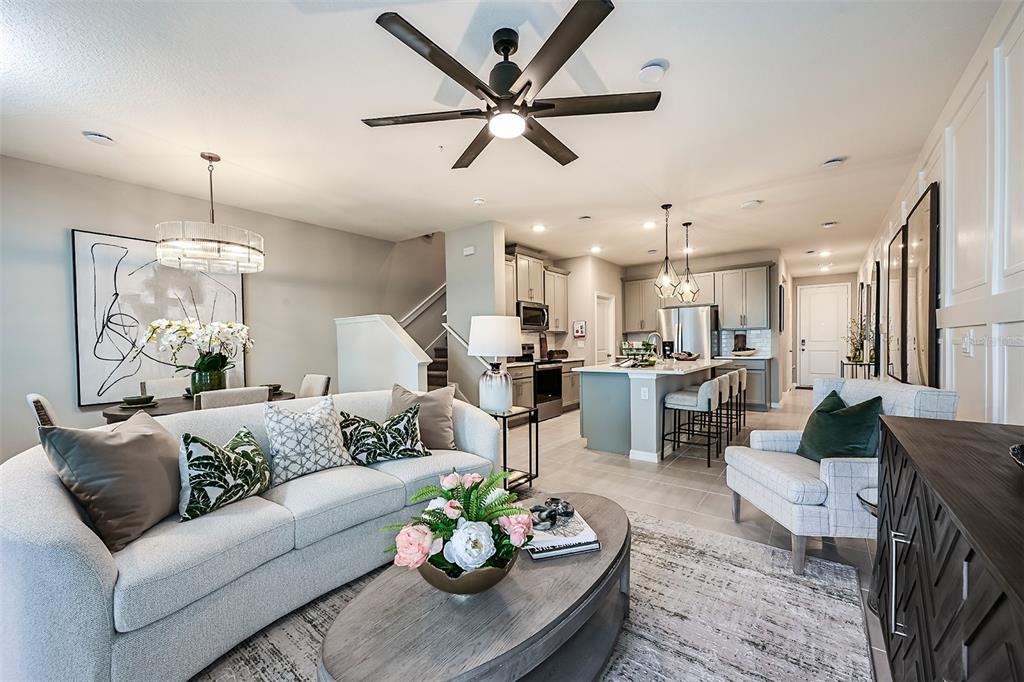 551 Southern Edge Way Sanford, FL 32771 - Photo 8 of 15 a living room with furniture kitchen view and a chandelier