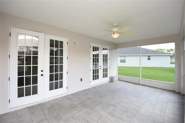 an empty room with windows and entryway