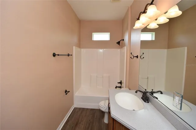 a bathroom with a sink vanity granite and a mirror