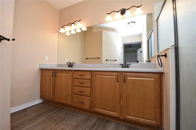 a bathroom with a granite countertop sink a mirror and a vanity