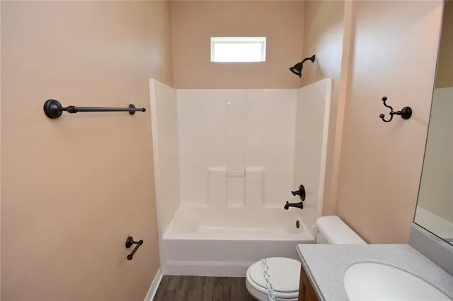a bathroom with a toilet and a bath tub