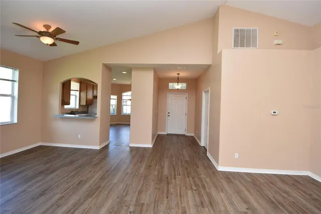 a view of a house with wooden floor and a ceiling fan