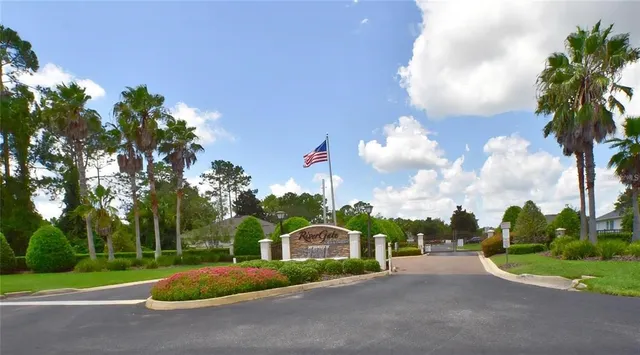 a front view of a house with a yard and fountain in middle