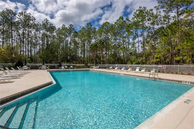 a view of a swimming pool with a yard