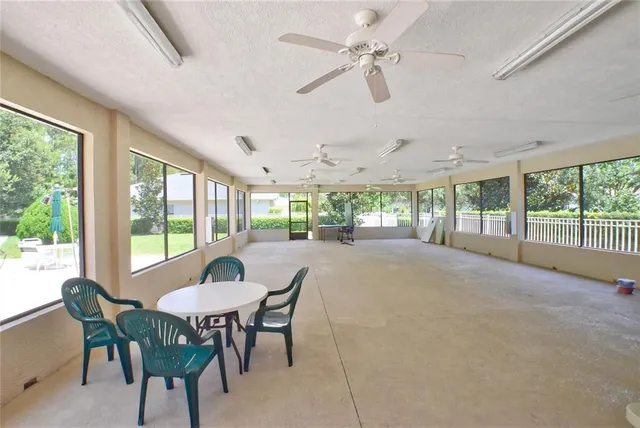 a view of a dining room with furniture large windows and wooden floor