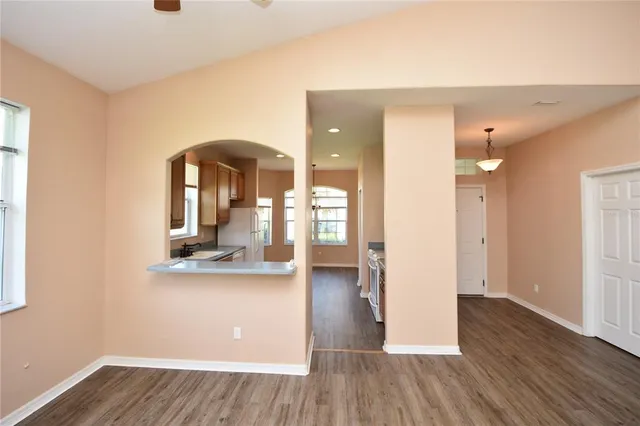 a view of a living room and kitchen with wooden floor