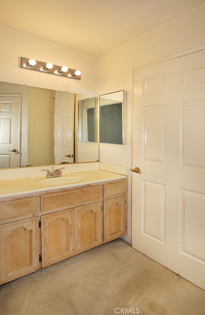 8032 Rose Street, Unit 13 Paramount, CA 90723 - Photo 14 of 25 a spacious bathroom with a double vanity sink and a mirror