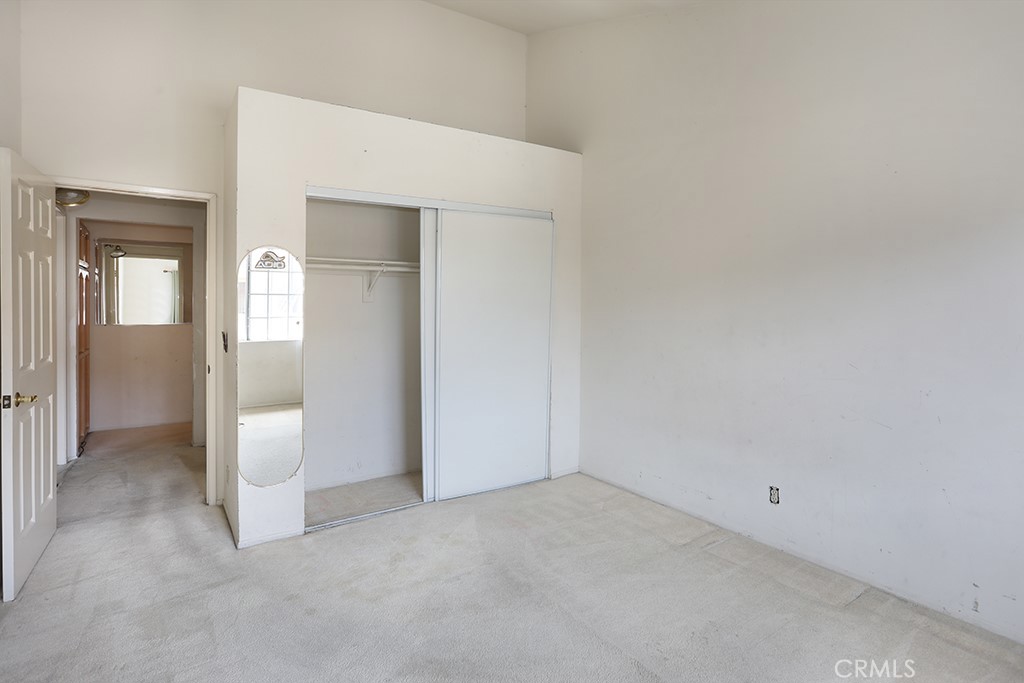 8032 Rose Street, Unit 13 Paramount, CA 90723 - Photo 23 of 25 an empty room with an entryway