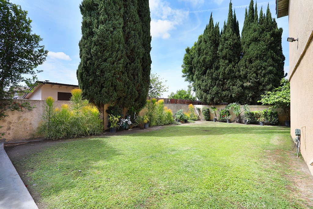 8032 Rose Street, Unit 13 Paramount, CA 90723 - Photo 3 of 25 a view of a trees in a yard
