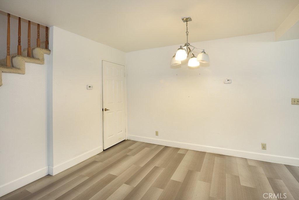 8032 Rose Street, Unit 13 Paramount, CA 90723 - Photo 6 of 25 a view of a room with wooden floor and white walls