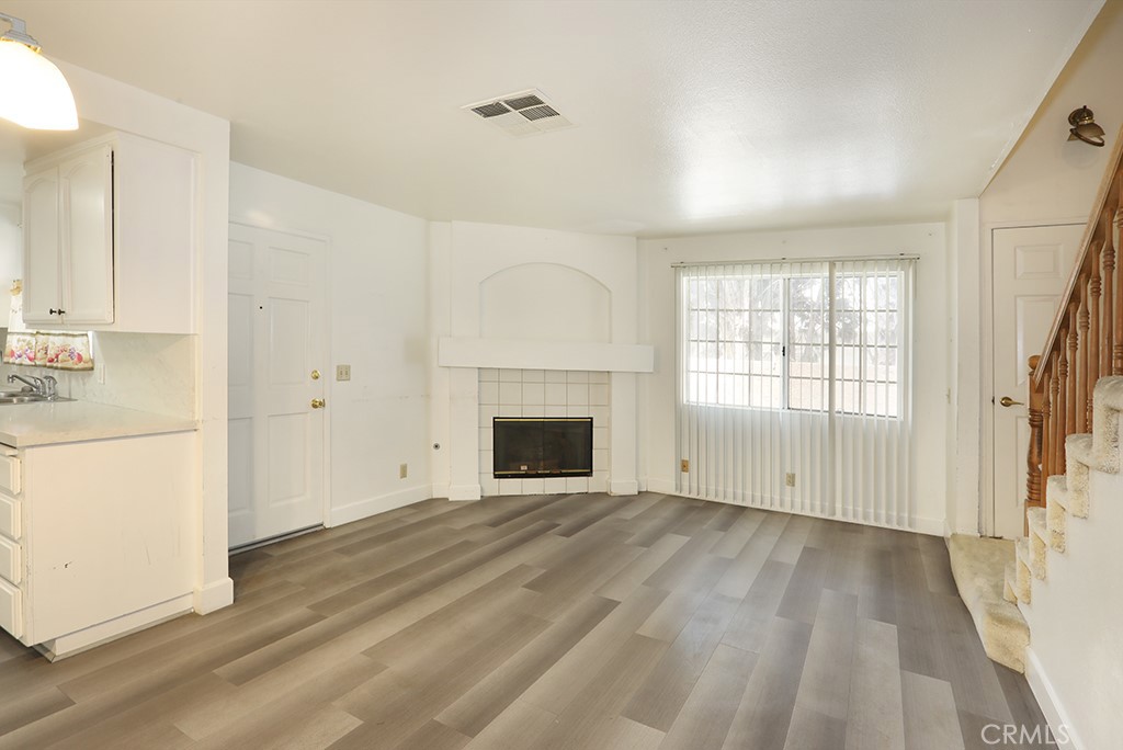 8032 Rose Street, Unit 13 Paramount, CA 90723 - Photo 8 of 25 a view of empty room with wooden floor and fan