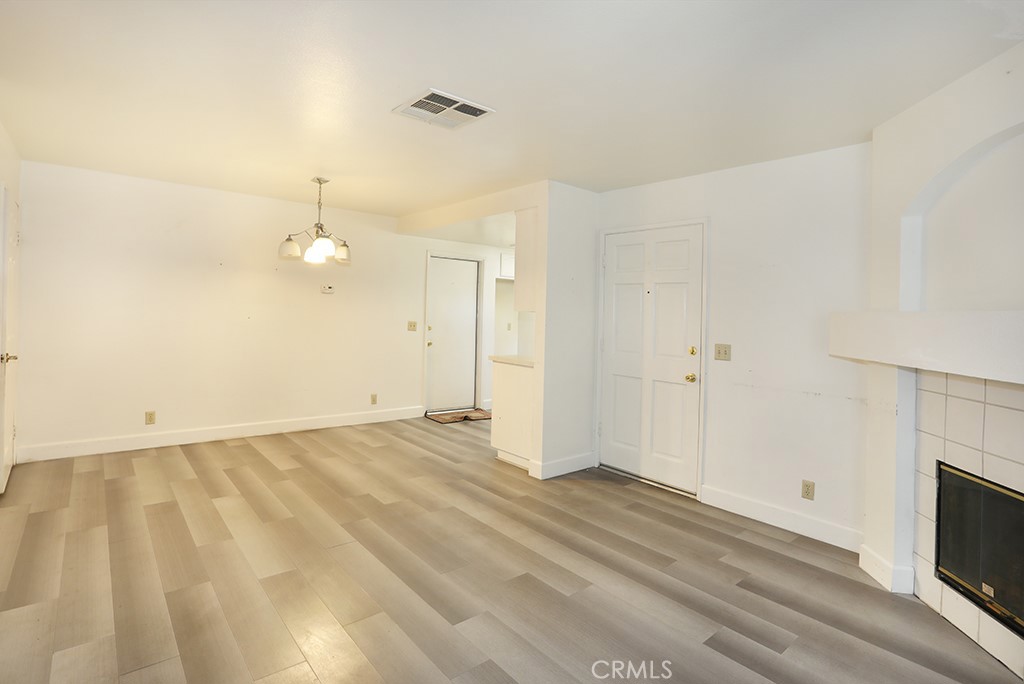 8032 Rose Street, Unit 13 Paramount, CA 90723 - Photo 9 of 25 a view of an empty room with a fireplace