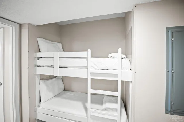 a bedroom with a bed and a chair