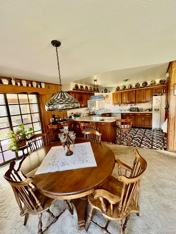 a living room with furniture a flat screen tv and a floor to ceiling window