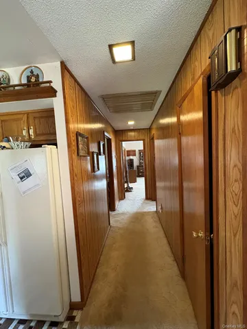 a hallway with sliding door and stairs