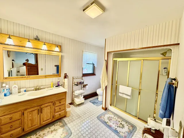 a spacious bathroom with a double vanity sink and a mirror