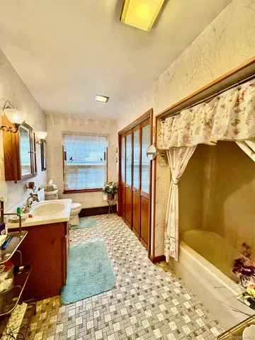 a bathroom with a sink a mirror and a bathtub